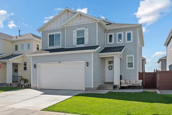 Two-story residence with light gray siding, white trim, and a prominent front entry