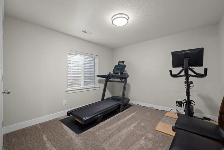 Recessed window with blinds, overhead flush-mount lighting, and neutral wall paint