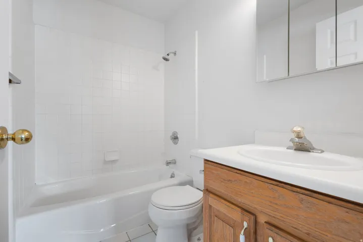 White tiled tub shower combination