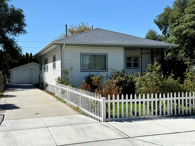 White vinyl siding exterior with a grey shingle roof