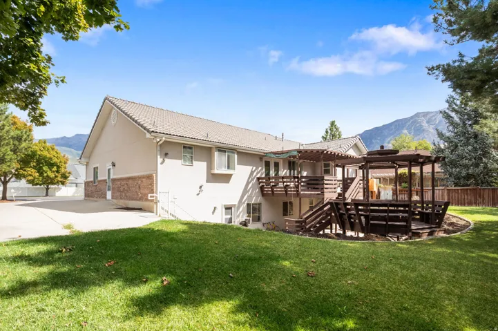 Multi-level rear deck with an integrated pergola and secondary gazebo structure