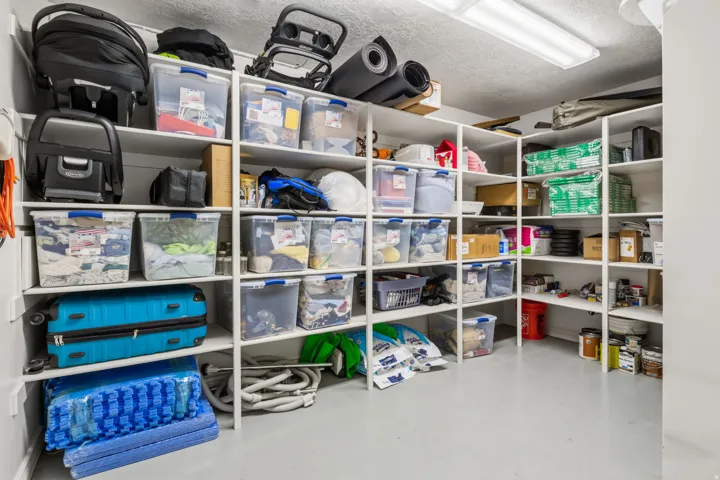White built-in shelving, durable flooring, and overhead fluorescent lighting
