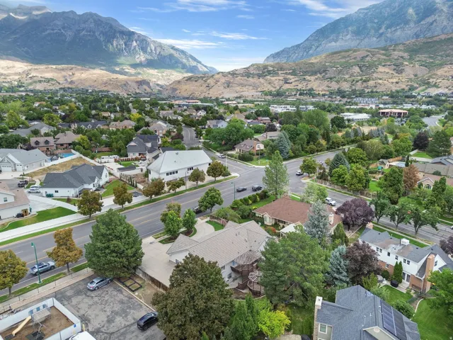 Mountain backdrop with residential properties and paved roadways