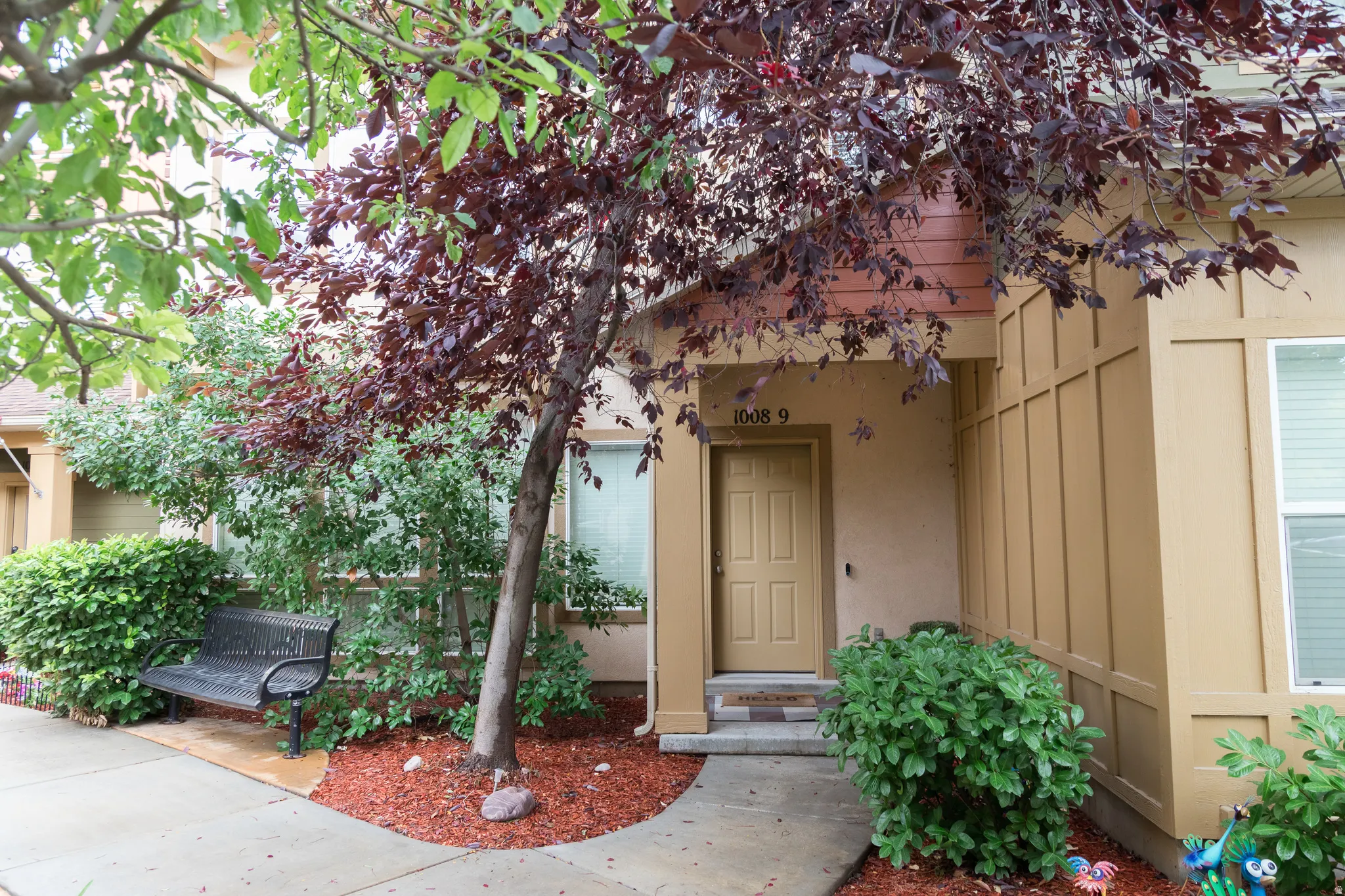 Covered entry with recessed lighting, paneled door, and side-mounted light fixture