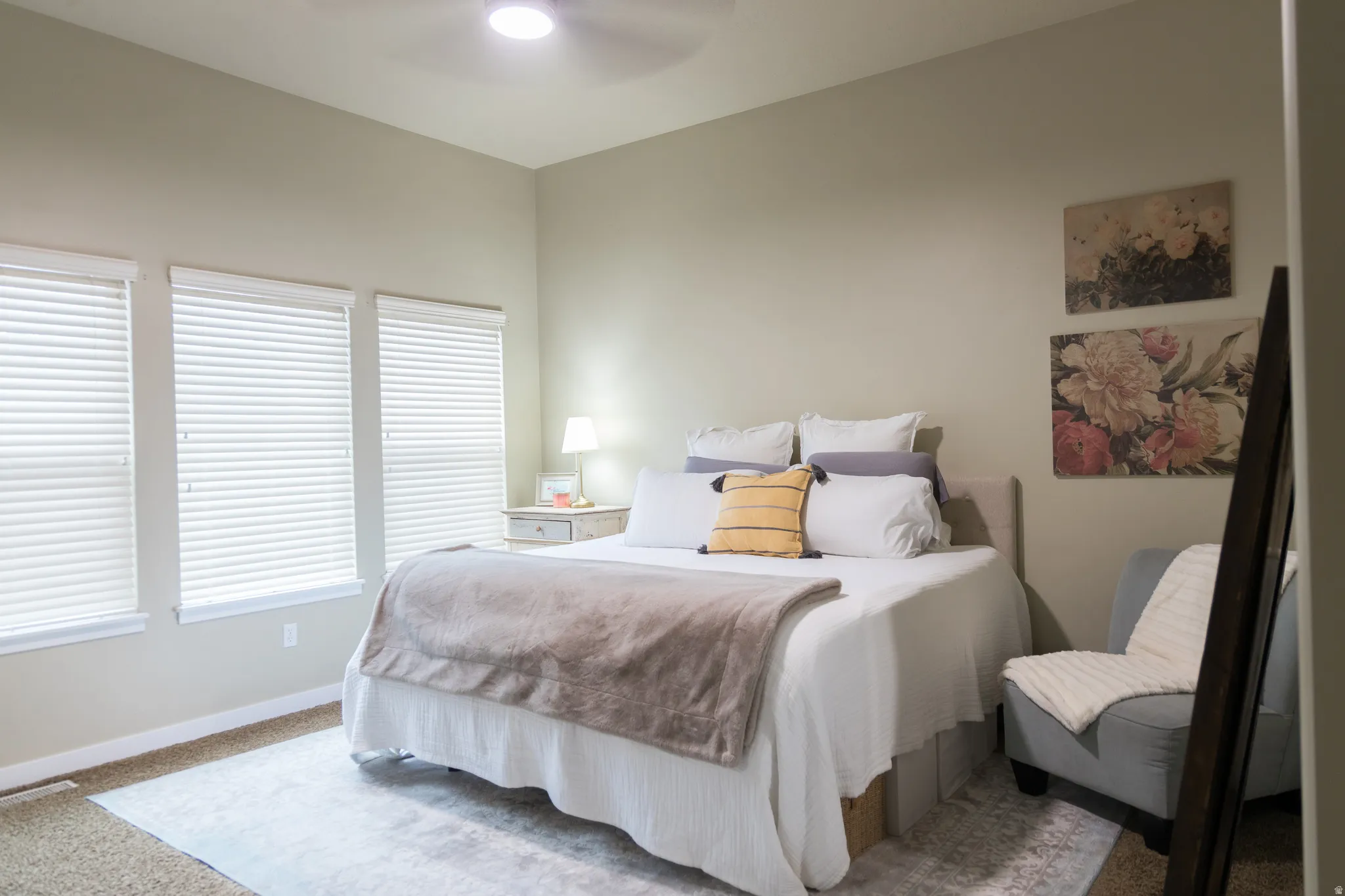 Recessed lighting, ceiling fan, and multiple windows with blinds