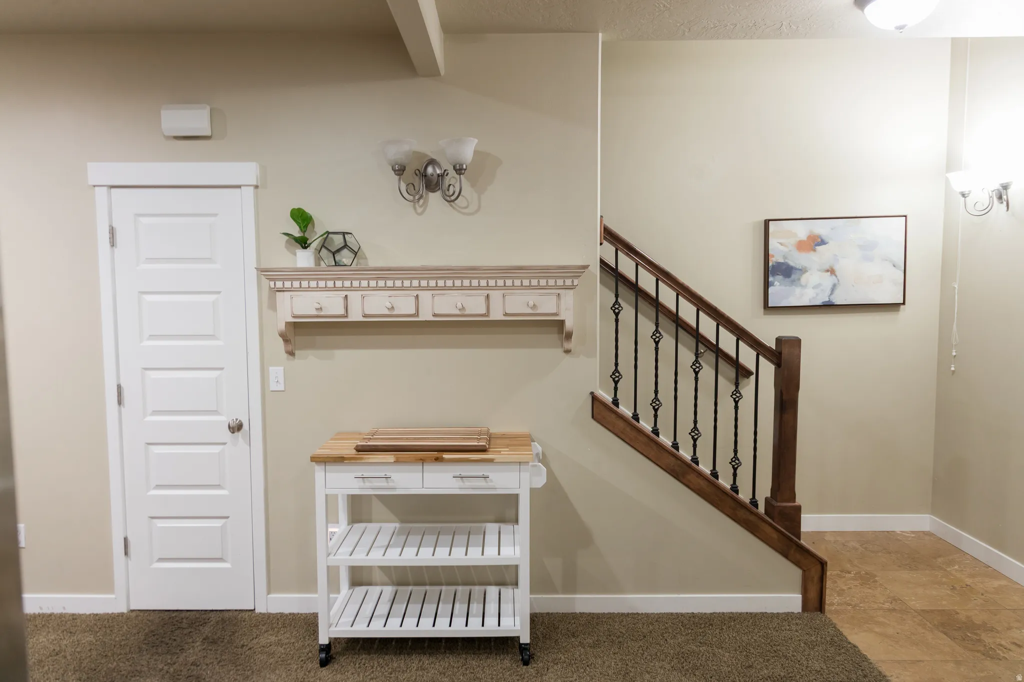 Staircase with wood newel post and wrought iron balusters