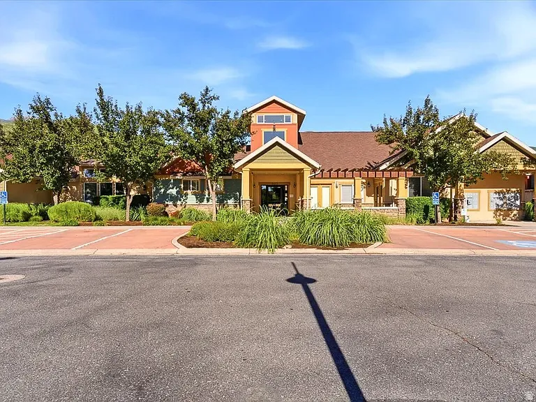 Multi-level building with varied exterior finishes, including stucco and stone accents