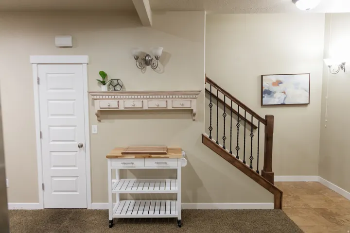 Staircase with wood newel post and wrought iron balusters