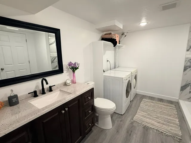 Dark wood-finish vanity with a light-toned countertop and undermount sink