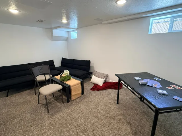 Recessed lighting, wall-to-wall carpeting, and an egress window