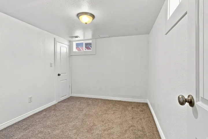 Recessed window, paneled interior door, and overhead ceiling light fixture