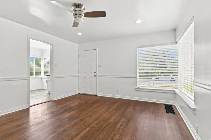 Hardwood flooring with white baseboards, recessed lighting, and a ceiling fan