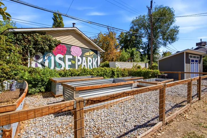 Gated garden area with raised beds and mural