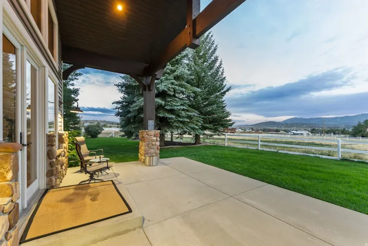 Covered patio with stone pillars and exposed wood beams