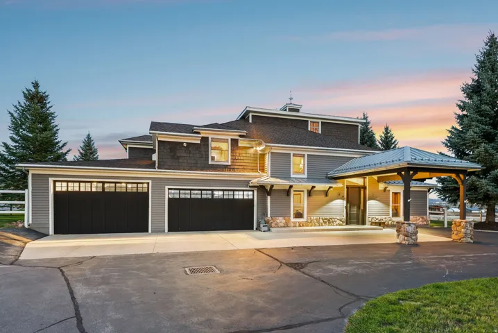 Multi-level exterior with shingle siding and stone accents