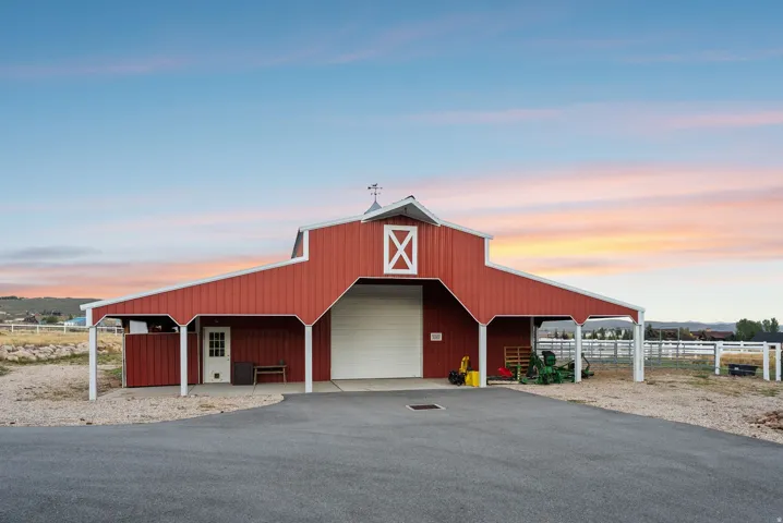 Red barn structure with white trim and cupola