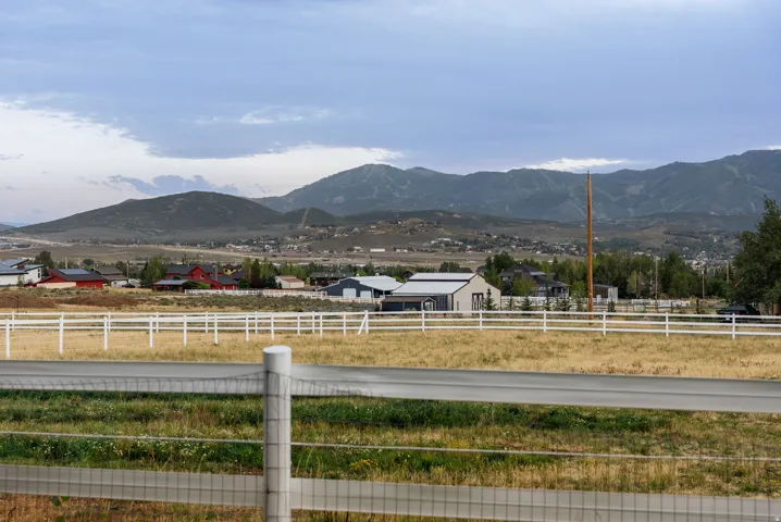 Expansive fenced field with distant mountain range