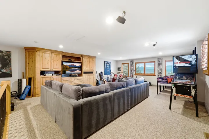 Recessed lighting, wood-finish built-in cabinetry, carpeted flooring, and wood-framed windows