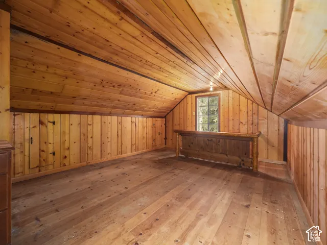 Wood-paneled walls and ceiling with sloped design