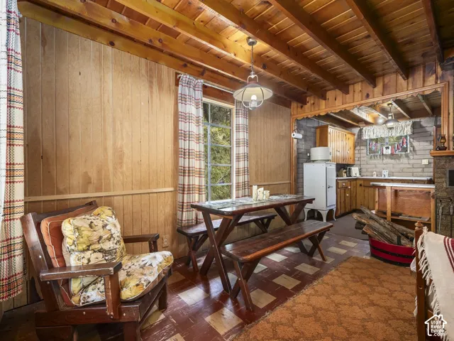 Wood-paneled walls and exposed beam ceiling
