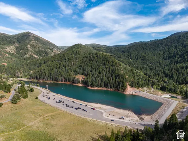 Mountainous landscape featuring a prominent lake and surrounding evergreen forests