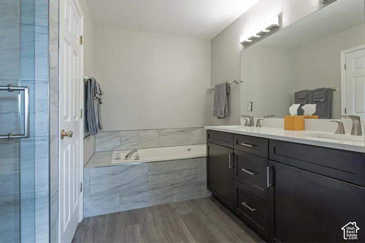 Dual vanity with white countertop, dark wood-finish cabinetry, and brushed nickel fixtures