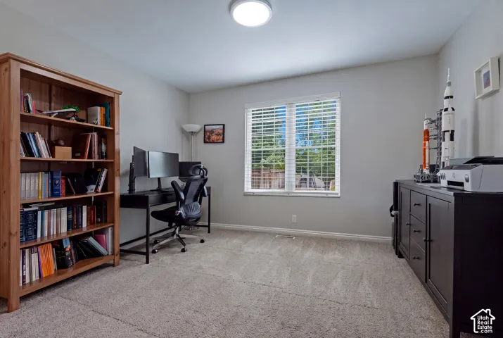 Neutral wall color, window with horizontal blinds, flush mount ceiling light, and carpeted flooring