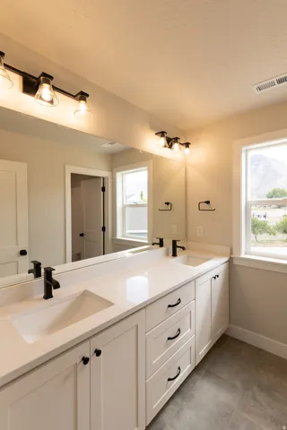 Main bathroom that separates toilet/tub and sinks.