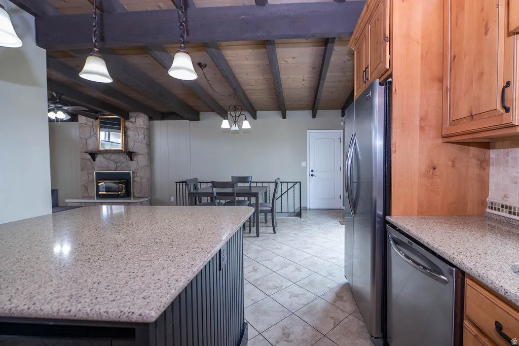 Kitchen featuring wood cabinetry, stainless steel appliances, and a light-toned countertop