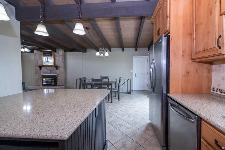 Kitchen featuring wood cabinetry, stainless steel appliances, and a light-toned countertop