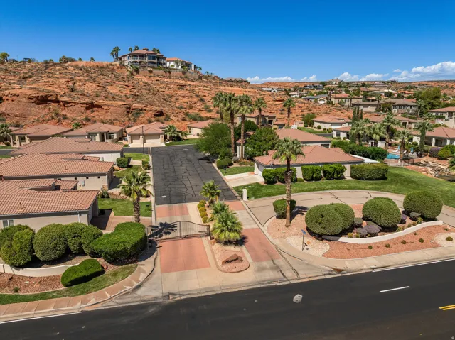 Community setting with red rock formations and mature palm trees