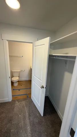 Recessed lighting and a white toilet