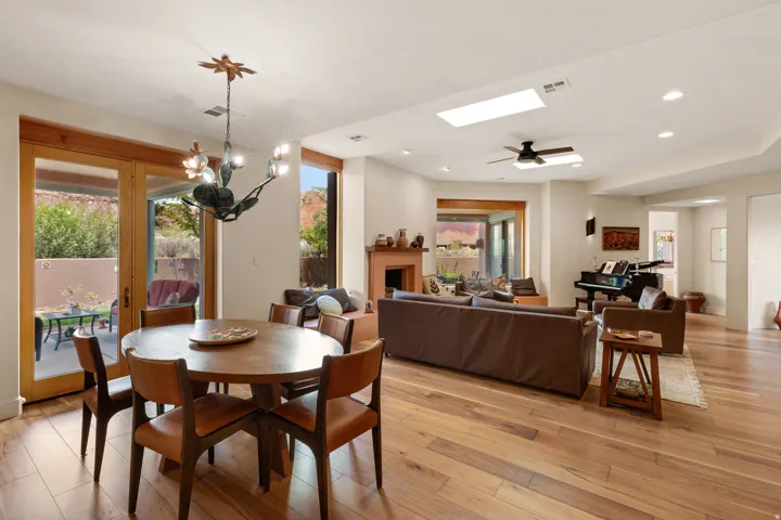 Wood-finish flooring throughout, featuring a living area with a fireplace and an open dining space