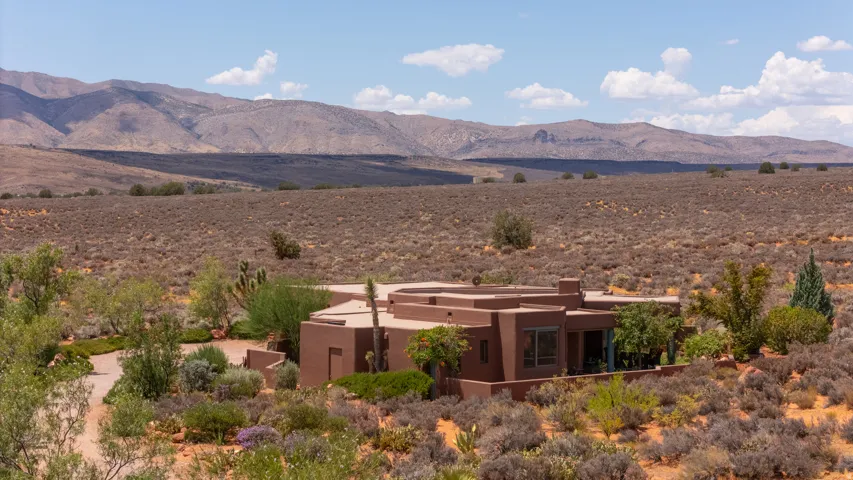 Southwestern-style architecture featuring a flat roofline and stucco exterior