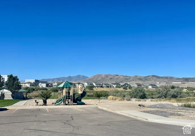 Community park featuring a play structure with slides and a covered gazebo