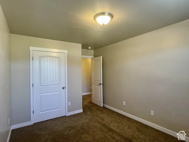 Neutral wall paint, white trim, and ceiling-mounted light fixture
