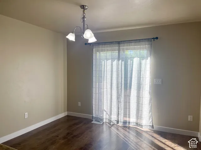 Wood-finish flooring with neutral wall tones and a ceiling-mounted light fixture