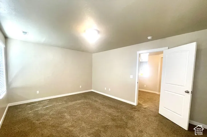 Neutral-toned walls complement the brown carpet flooring