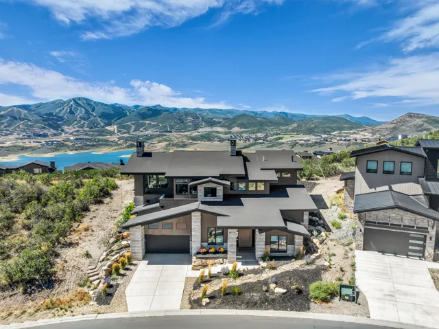 Contemporary multi-level exterior with dark siding and stone accents