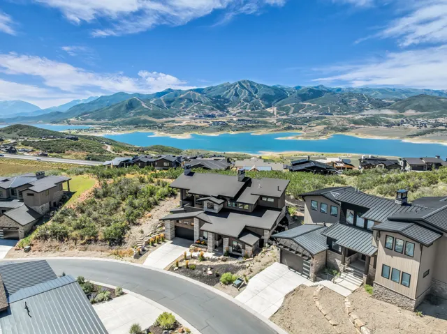 Contemporary exterior with a multi-level design, stone accents, and a dark metal roof
