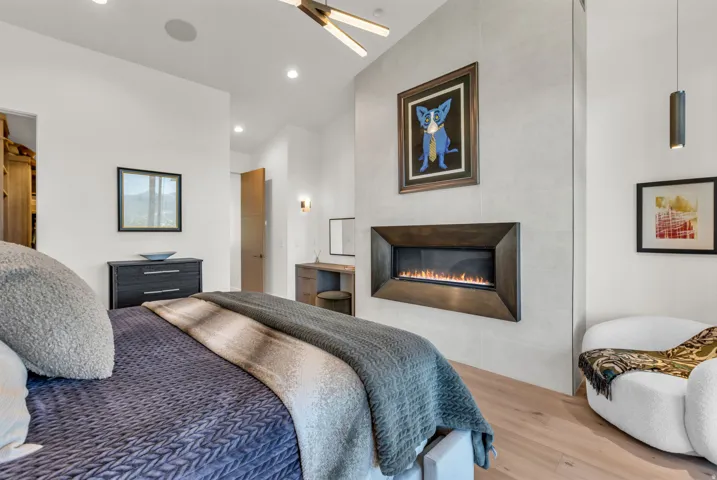 Built-in linear fireplace with a dark metal surround