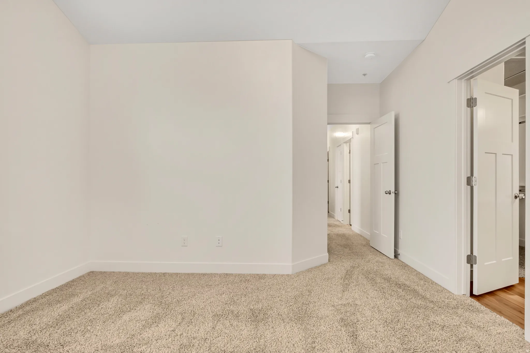 Soft neutral carpeting, white interior doors, and recessed lighting