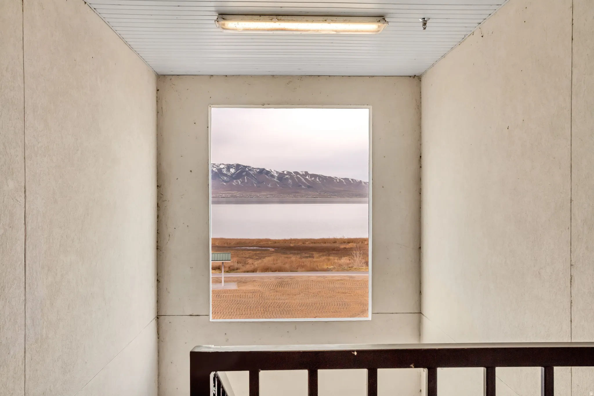 Window showcasing a scenic mountain and water backdrop