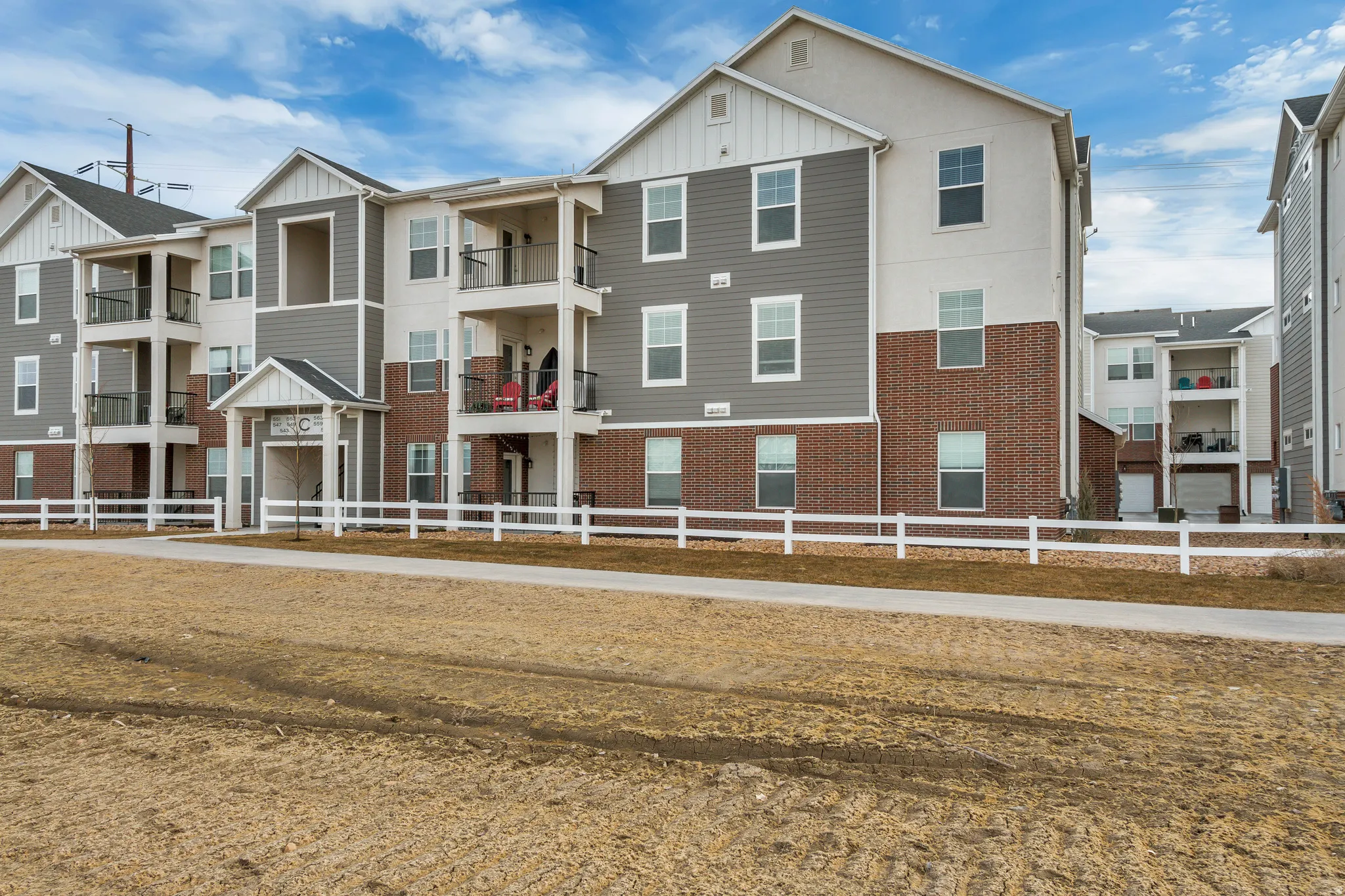 Multi-story building featuring brick, siding, and trim exterior