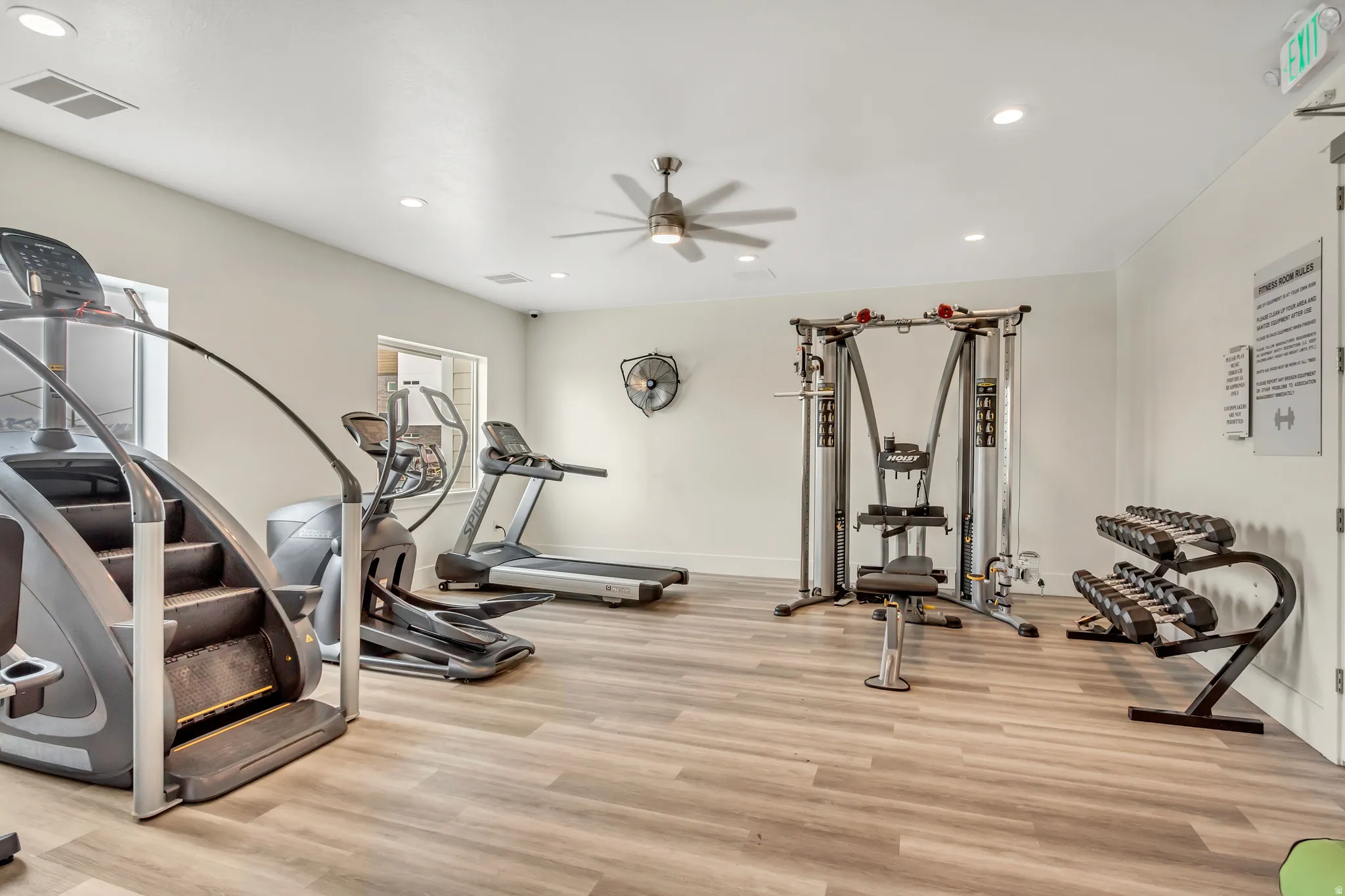 Fitness center with wood-finish flooring, recessed lighting, and a ceiling fan
