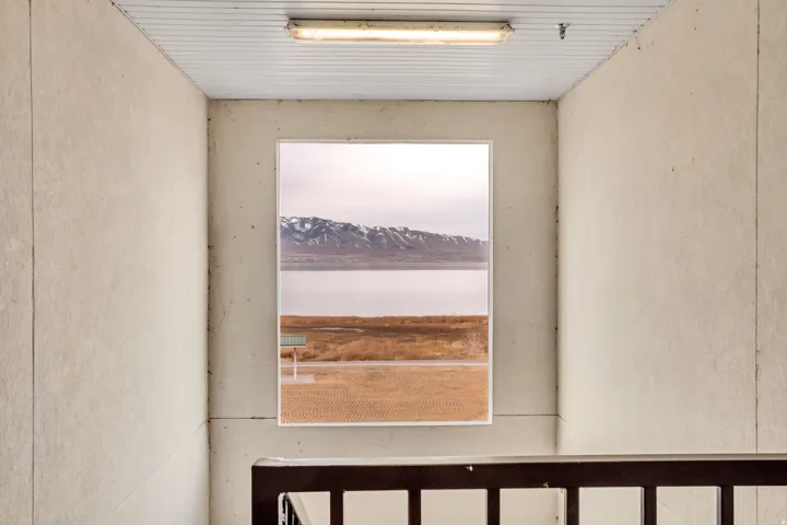 Window showcasing a scenic mountain and water backdrop