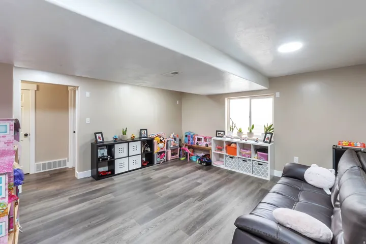 Recessed lighting, wood-finish flooring, and a large window provide ample illumination