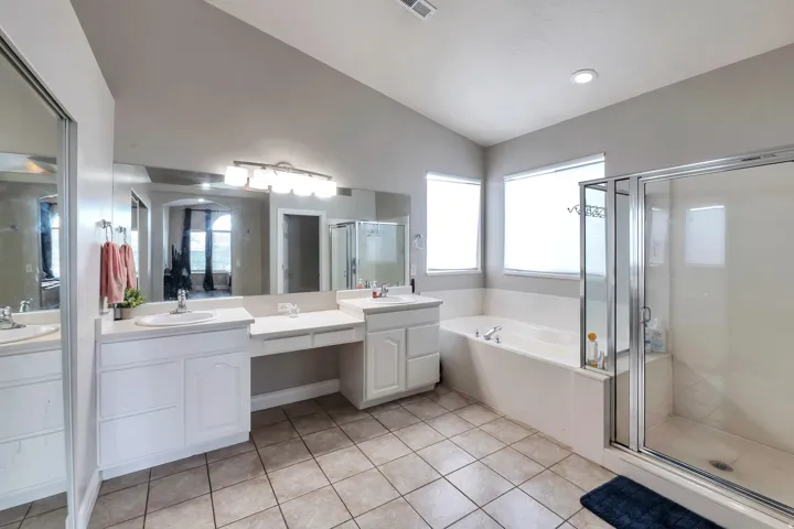 Double vanity with built-in makeup area, undermount sinks, and ample counter space