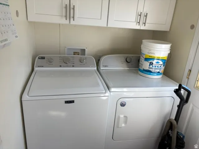 Laundry area featuring white cabinetry with brushed nickel hardware