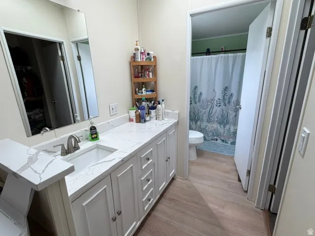 White vanity with integrated sink, stone-finish countertop, and brushed nickel faucet